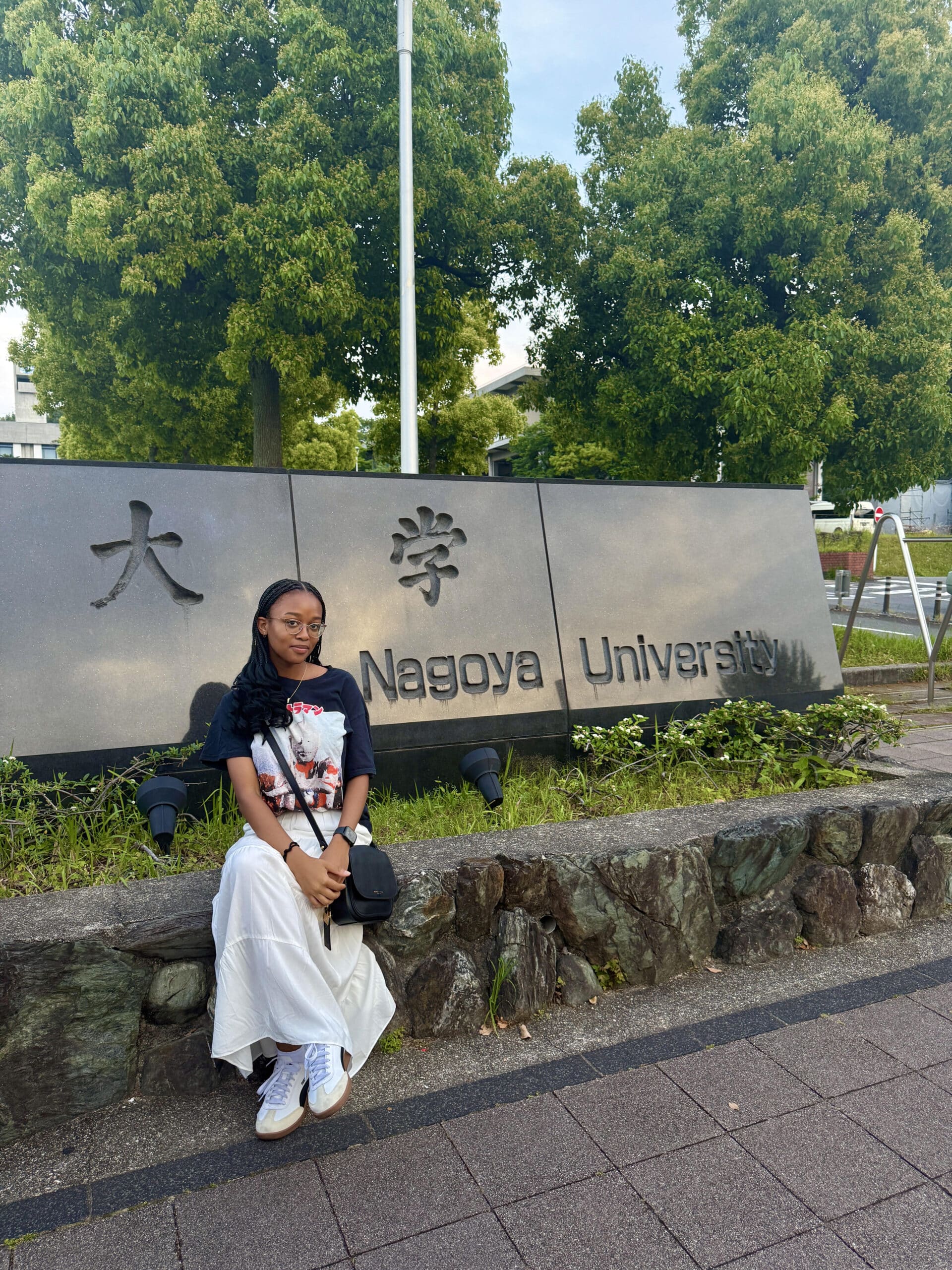 Girl in front of Nagoya University sign