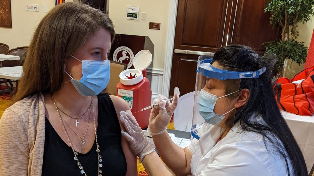 Lisa Chang administers COVID-19 vaccine