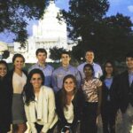 group of students with capitol in background