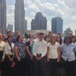 group of students with city in background