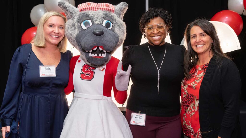 Three women with mascot