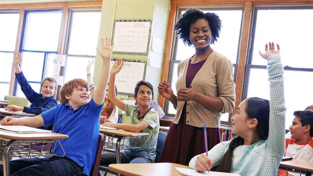 women teacher with male and female elementary students