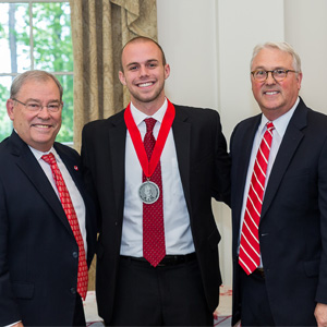 Photo of Hunter Davis with Benny Suggs, associate vice chancellor of alumni relations (left), and NC State Chancellor Randy Woodson (right).