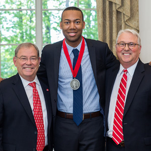 Photo of Tyrek Shepard with Benny Suggs, associate vice chancellor of alumni relations (left), and NC State Chancellor Randy Woodson (right).