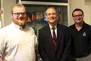 Photo of Professor Lee Craig, head of the Department of Economics, with two of this year's honored undergraduate students, Thomas Gromko and Bradley Anderton
