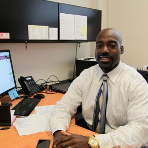 Photo of Ayo Agunbiade in his office at the NC State Jenkins MBA program