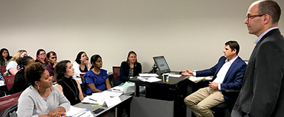 Scott Newnam, president and CEO of Audio Advice (seated, right) listened to students' discussing the Audio Advice case during the Jenkins MBA Oct. 16 evening class session at the program's RTP site.