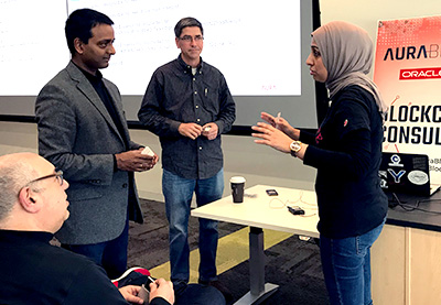 Sarah Khan, Poole College IT teaching assistant professor, discussed blockchain with presenters during a break in the session.