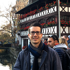 Cody Nagy, on a visit with friends to Strasbourg, France, just across the Germany-France border. A channel of the Rhine River that flows past the city is in the background.