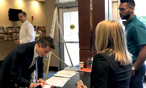 Evan James, a junior at UNC-W, signs in at the NC State Poole College Career Fair