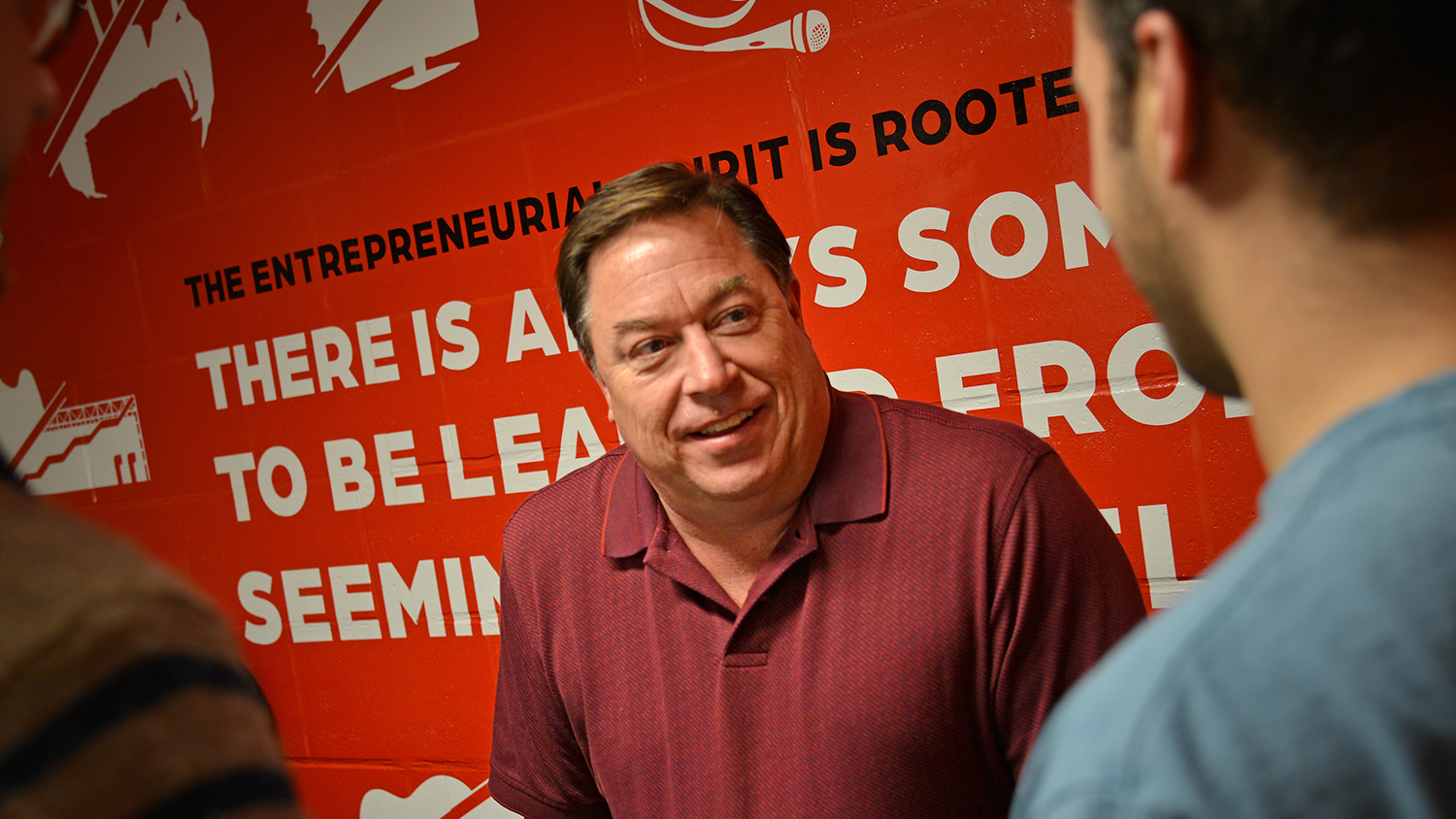 Photo of Jon Carr, Jenkins Professor of Entrepreneurship, talking with students at the Garage on NC State's Centennial Campus