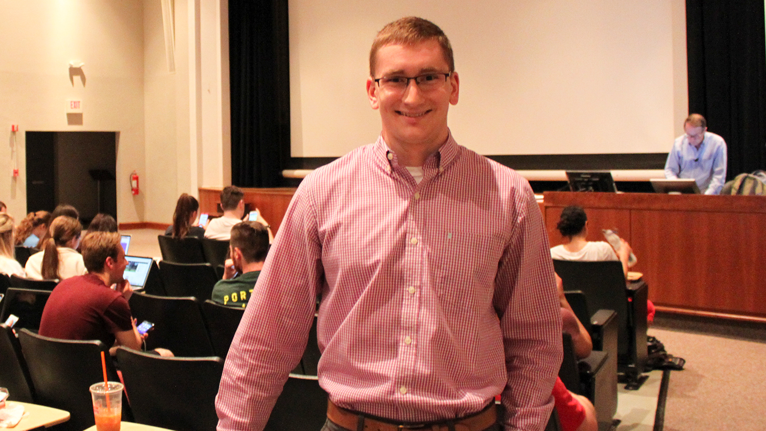 Photo of James Barrow ('17) after he gave a brief presentation at the start of a Poole College marketing class in the Nelson Hall Auditorium on what he learned while writing his book, "No Time to Lose..."