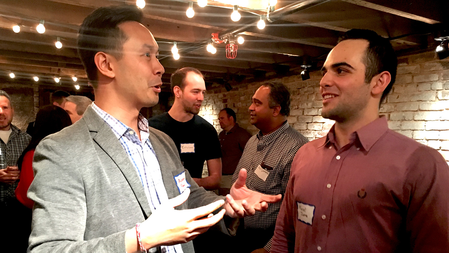 Andrew Poon, left, in discussion at an NC State Entrepreneurship mentor-student networking event.