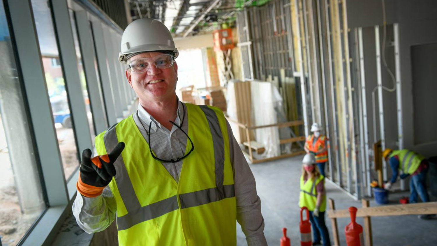 Jim Whitehurst wearing a hard hat at a construction site.