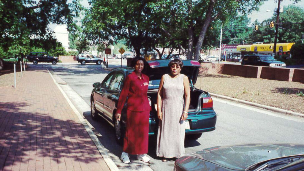 Terry Price (left) and Mary Williams load a car with commencement supplies for the spring 2004 ceremony. 