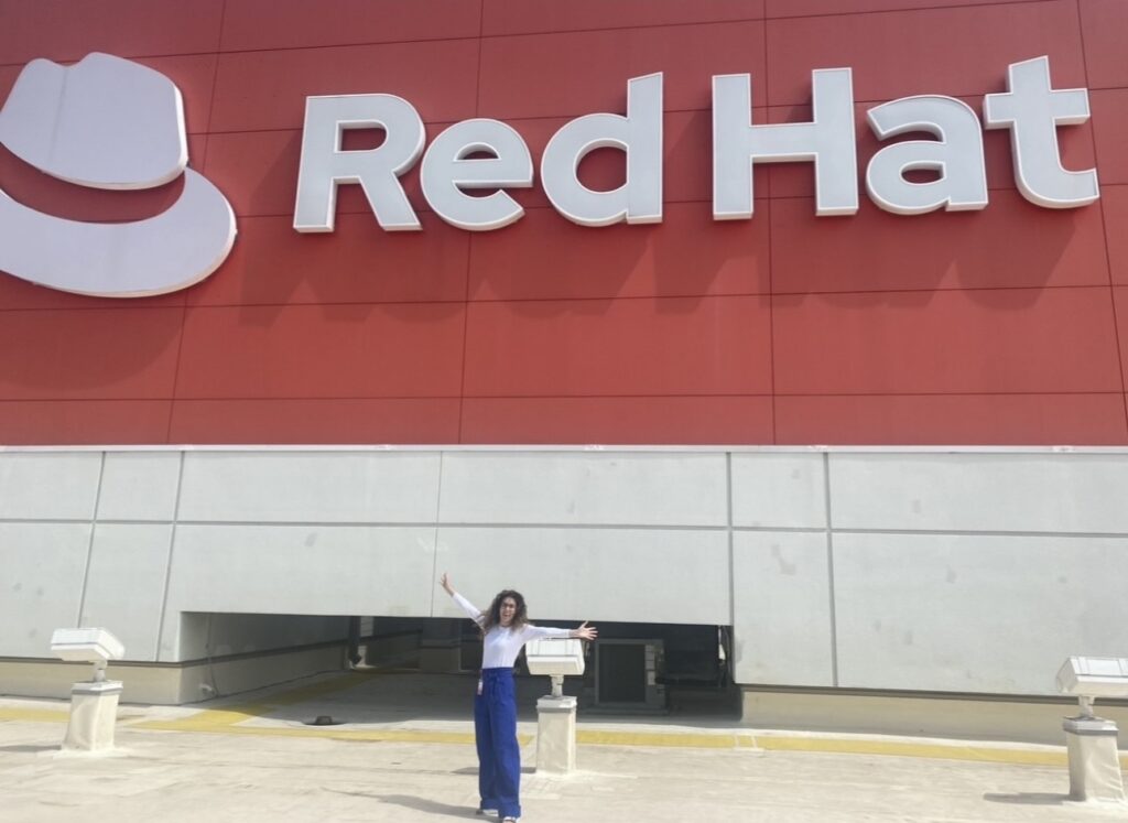 Heather Whitley stands outside Red Hat building