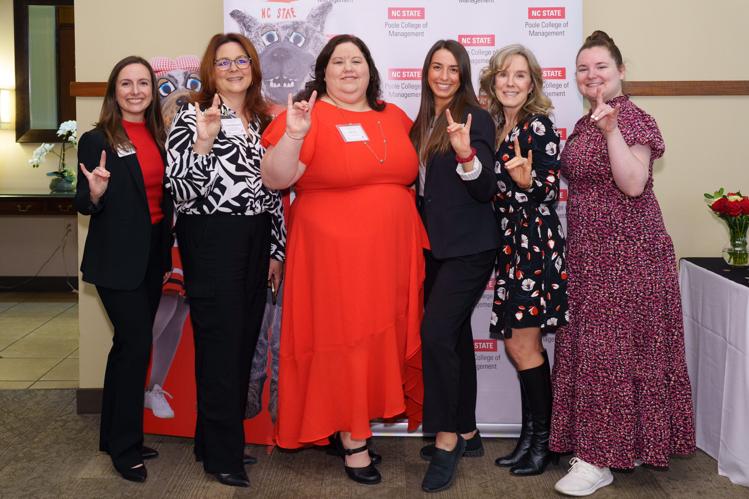 Poole Career Center employees making wolfpack sign