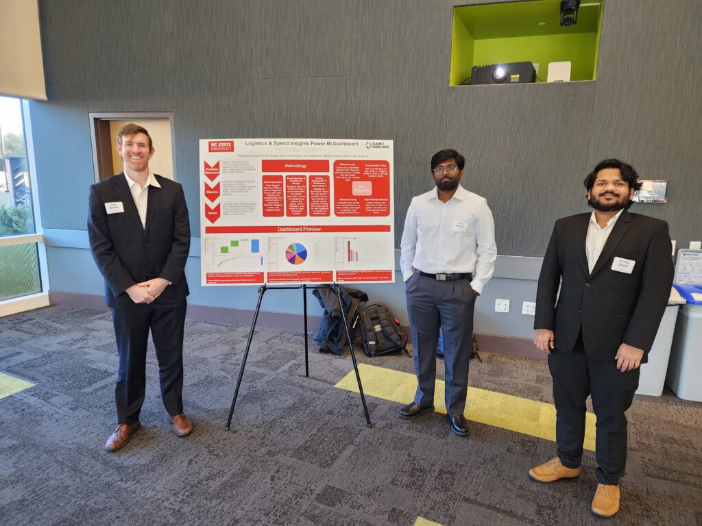 three students in front of board