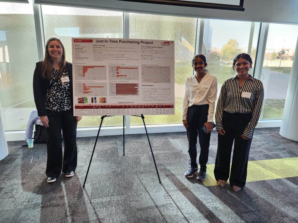 three students in front of board