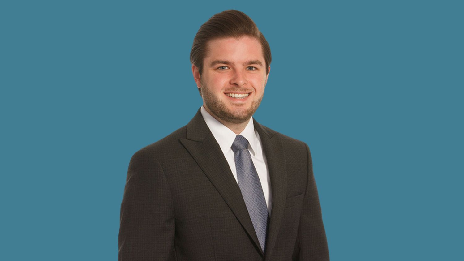 Nick Zanzot smiles wearing suit