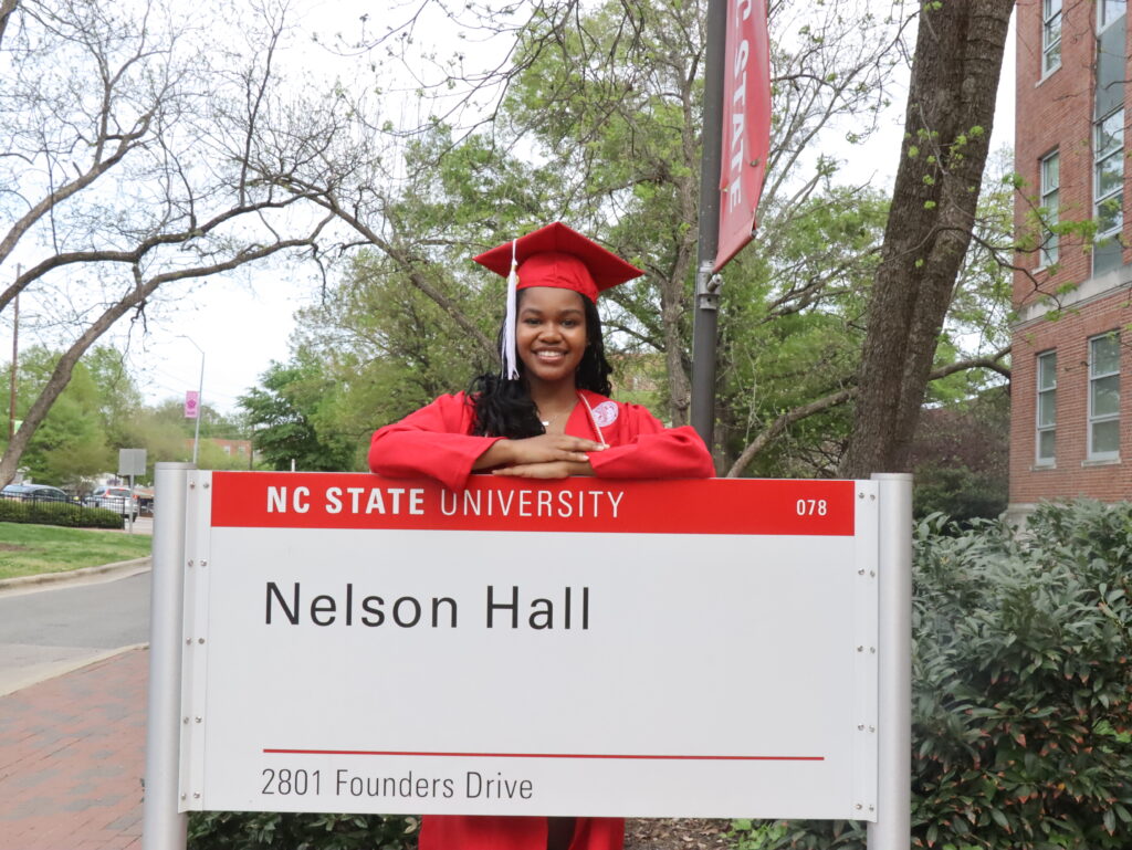 Cyrani Houston behind Nelson Hall sign