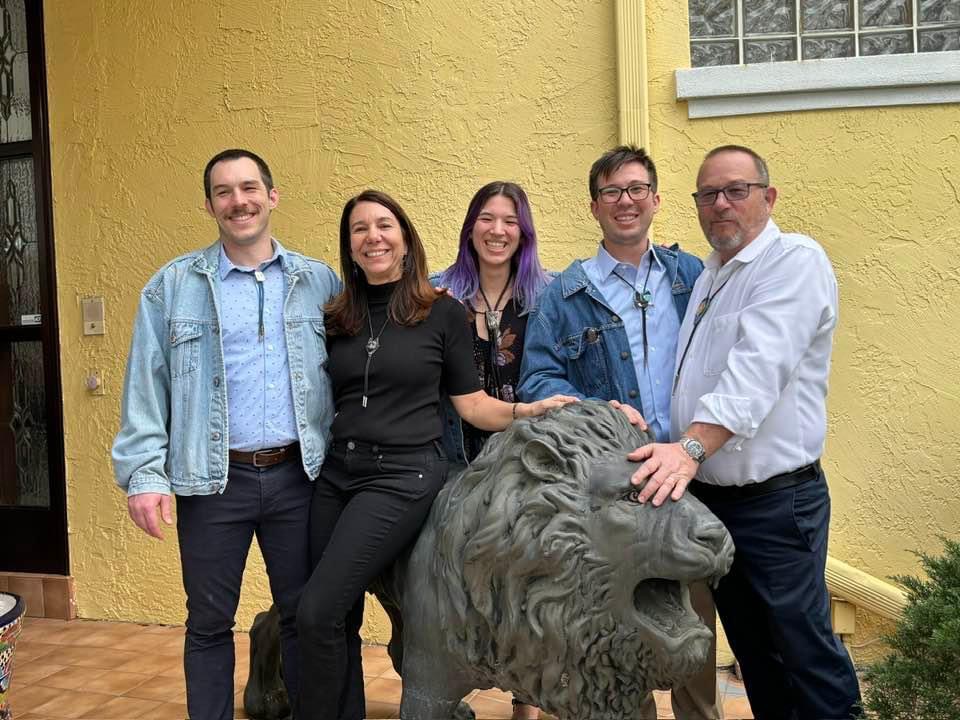 Eileen Taylor and her children by a lion statute