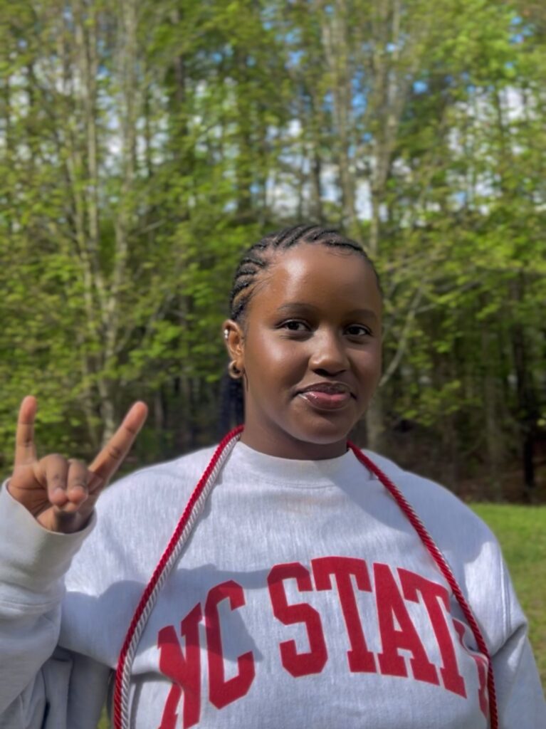 Yvonne Mbugua making wolfpack sign
