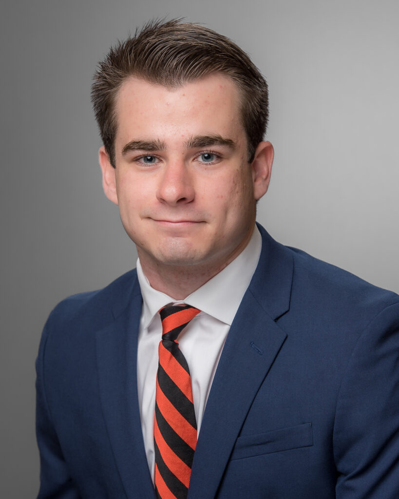 Eli Hill in blue jacket with striped tie