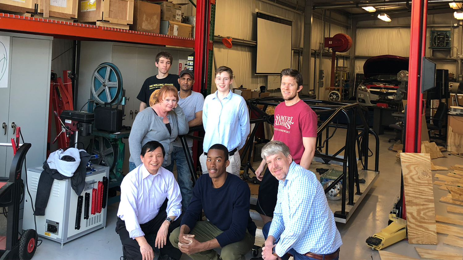Group of students and professors in a workshop.
