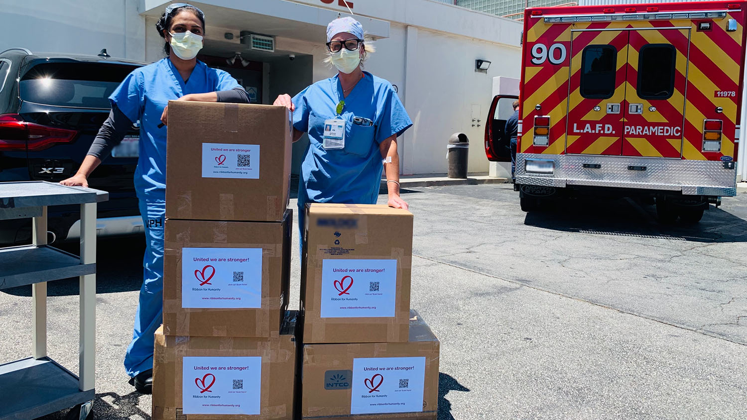 nurses stand with newly-delivered boxes of PPE