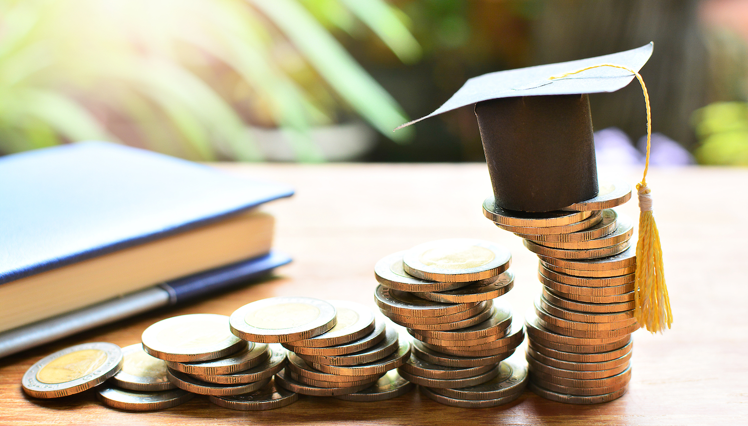 Hat,Graduation,Model,On,Coins,Saving,For,Concept,Investment,Education