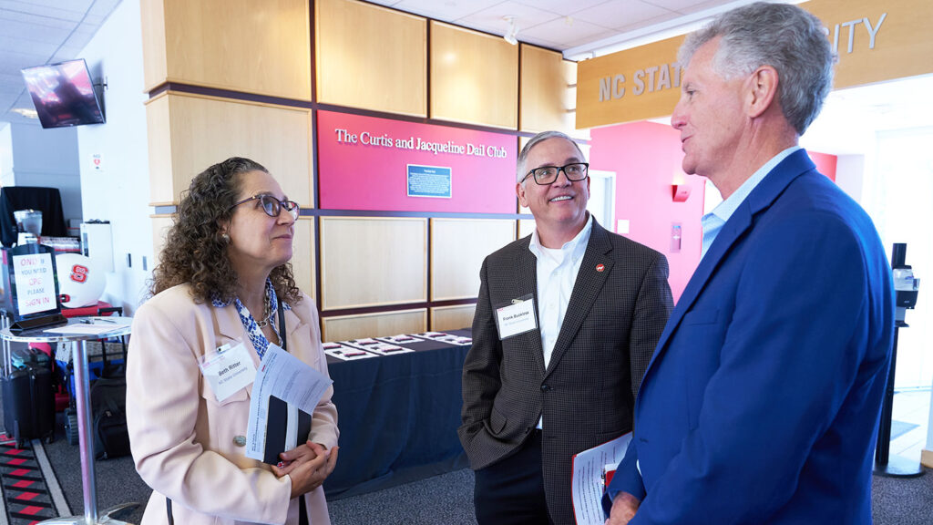 Beth Ritter, professor of practice of human resource management (left), talks with Stephen P. Zelnak Jr. Dean Frank Buckless and Mark Beasley, Alan T. Dickson Distinguished Professor of Accounting.