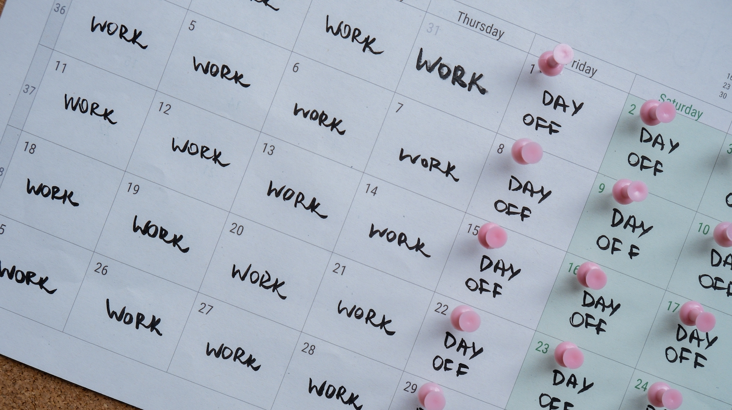 4 day work week printed calendar with pink pins on three days off in week weekend days four day working week concept. Modern approach doing business short workweek. Effectiveness of employees