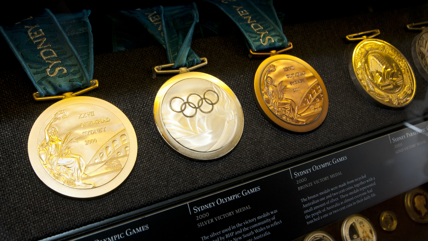 Four Olympic medals in a display case