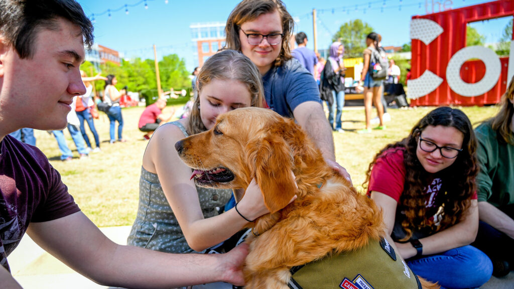 NC State students with a therapy dog