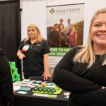 student in front of Farm Credit sign