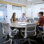 students talk around a table