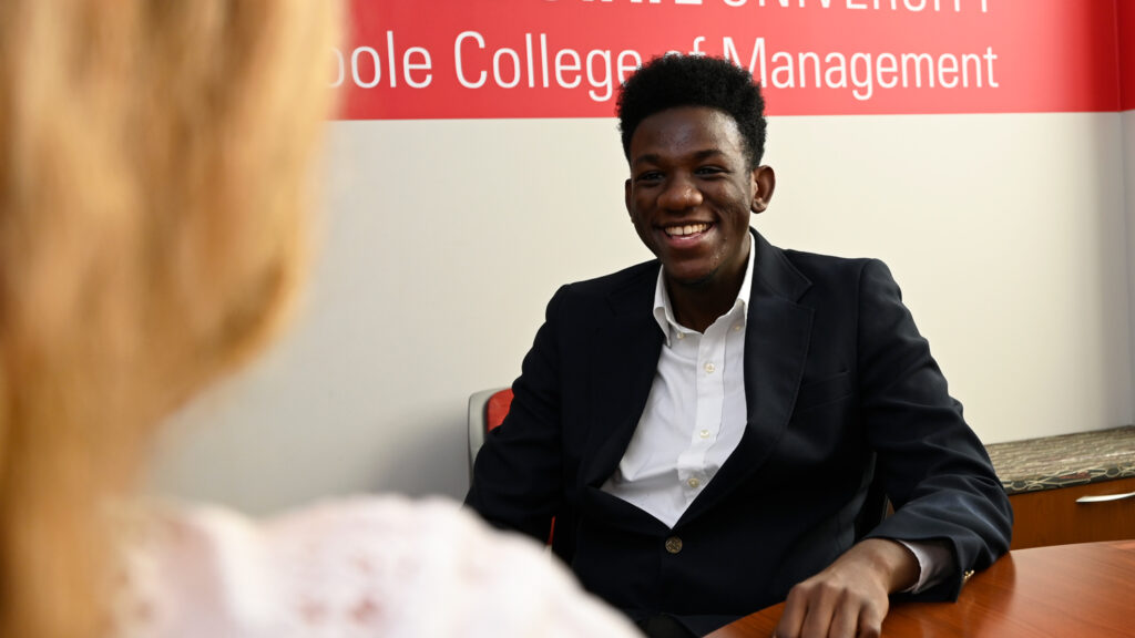 A Poole College undergraduate student smiles during an interview.
