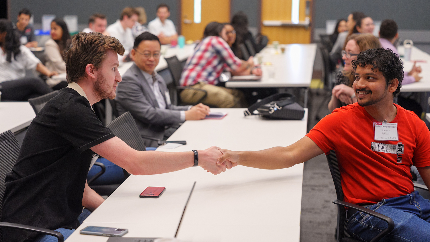 Two students shaking hands